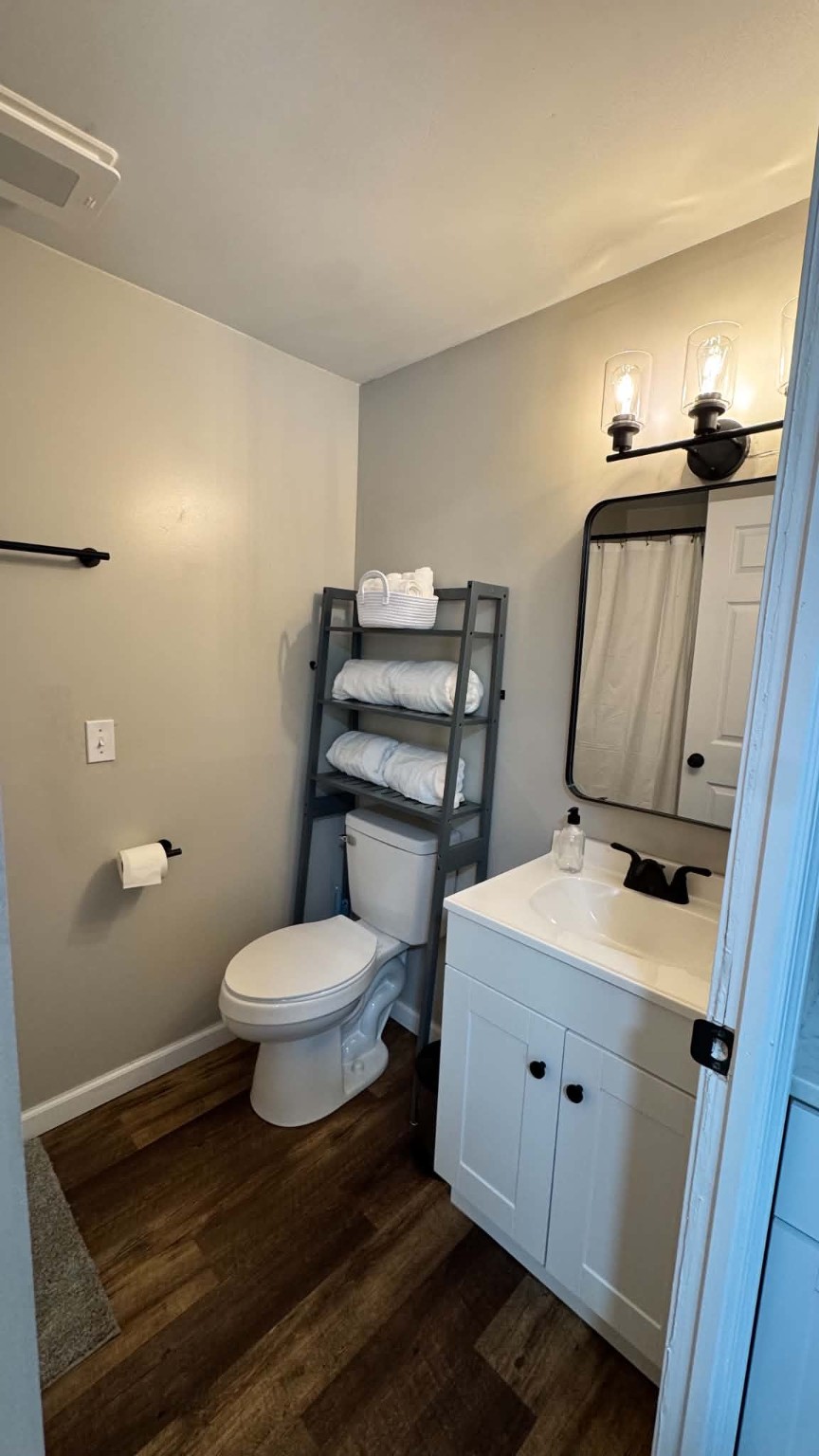 Unit 9 - Bathroom with vanity and stocked towel shelf