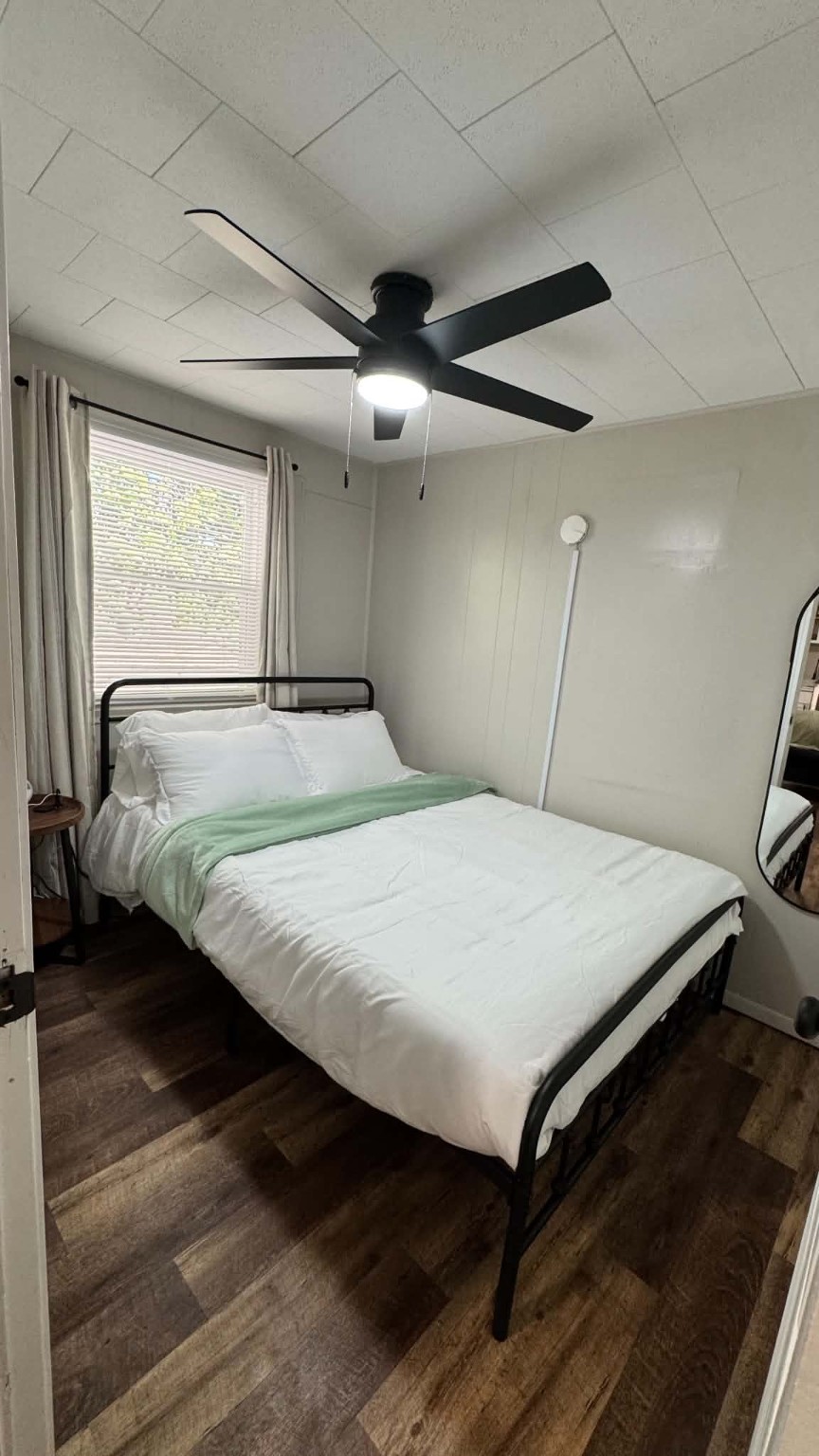Unit 9 - Queen bedroom with ceiling fan and natural light