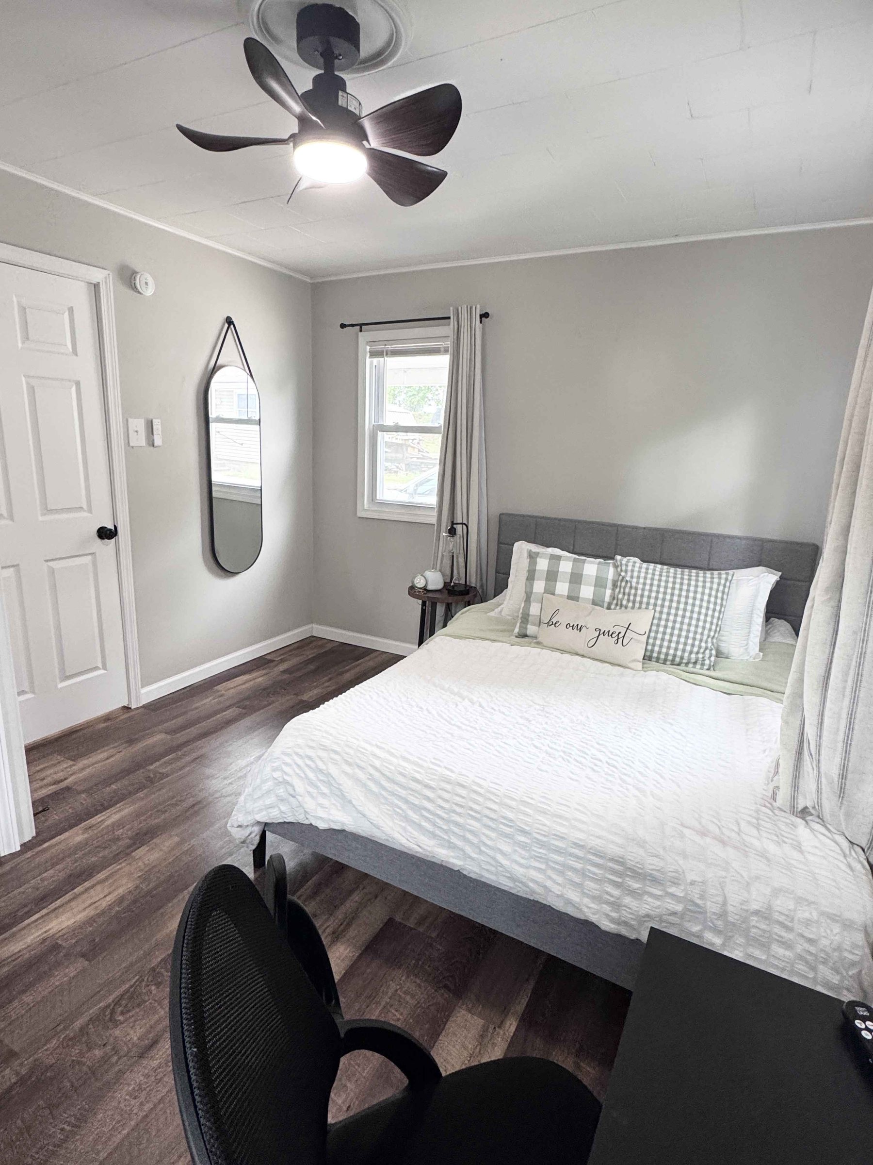 Unit 14 - Bedroom with queen bed, desk, TV, and natural light