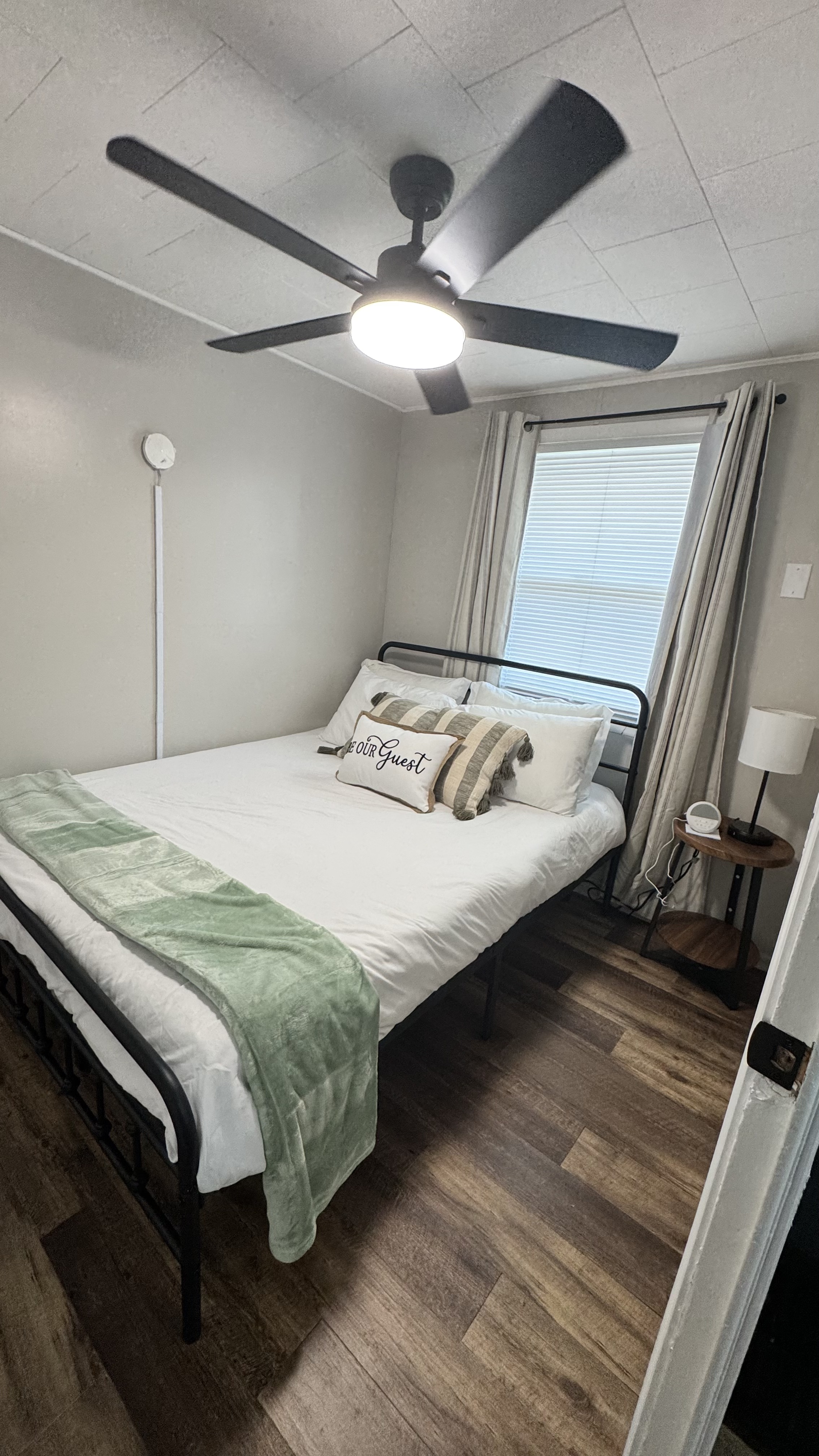 Unit 7 - Queen bedroom with ceiling fan and natural light