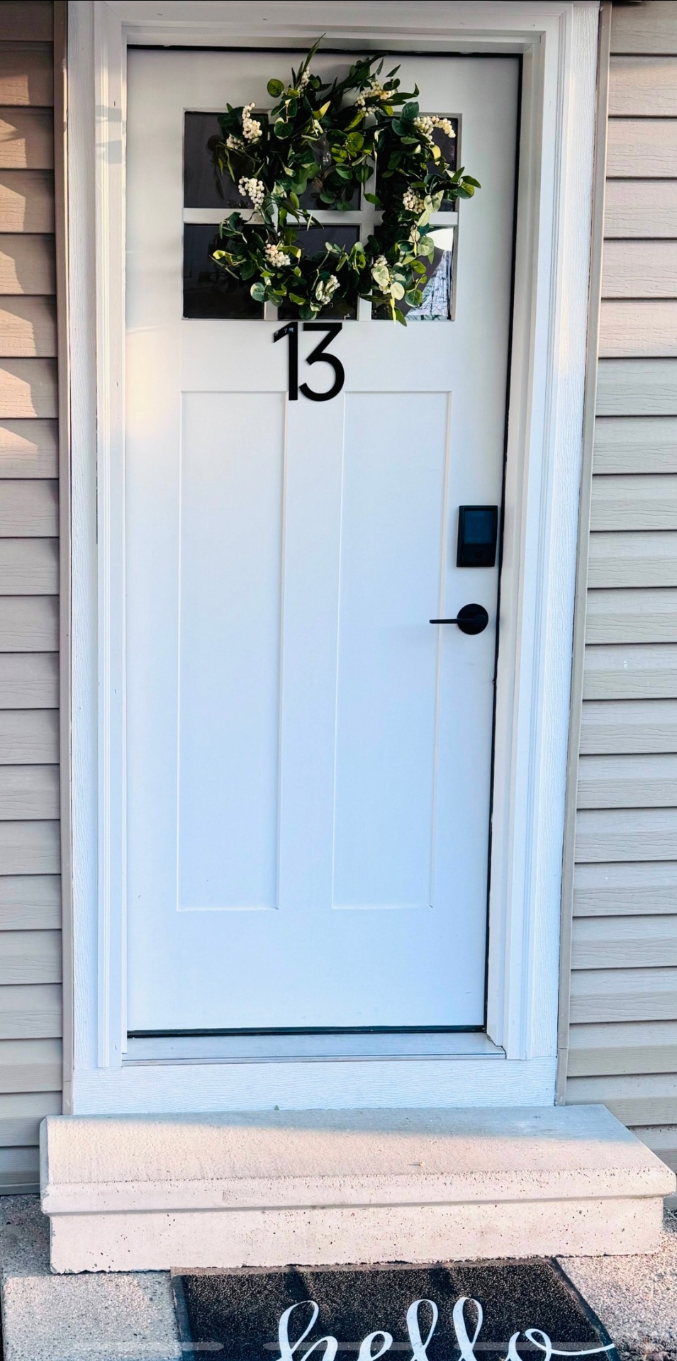 Cottage 13 - Welcoming white door with wreath and smart lock